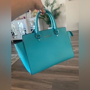 Barely used bag. 17 inches long, 9 inches high. Sky blue color.